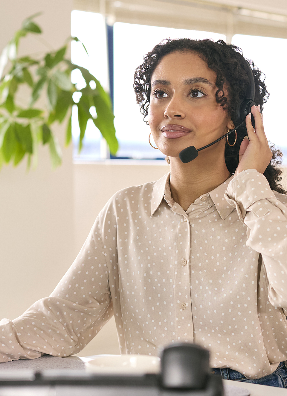Woman Wearing Headset Working In Office Call Centre Sitting At D